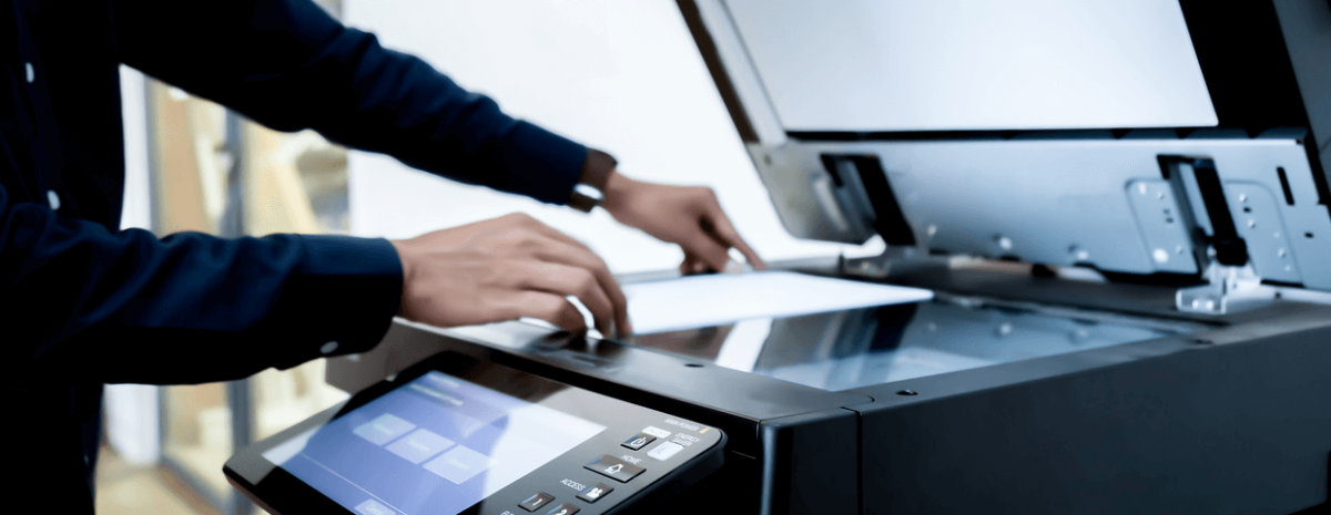 close up of a businessman putting paper on a multifunction printer scanner tray