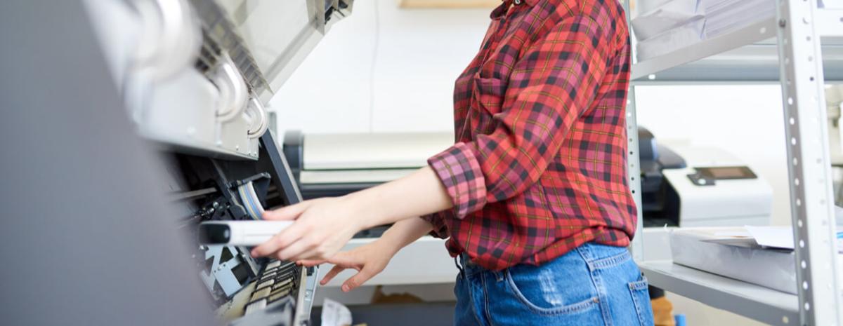 woman using wide format printer